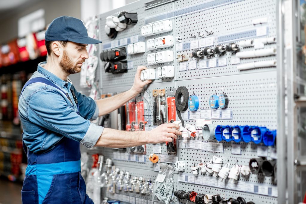 Elecrician choosing electrical goods in the shop